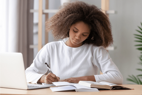 African American girl writing an essay.
