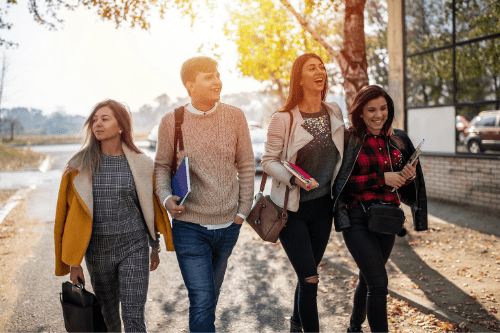 College students walking to class and laughing together