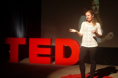 woman giving a TED talk
